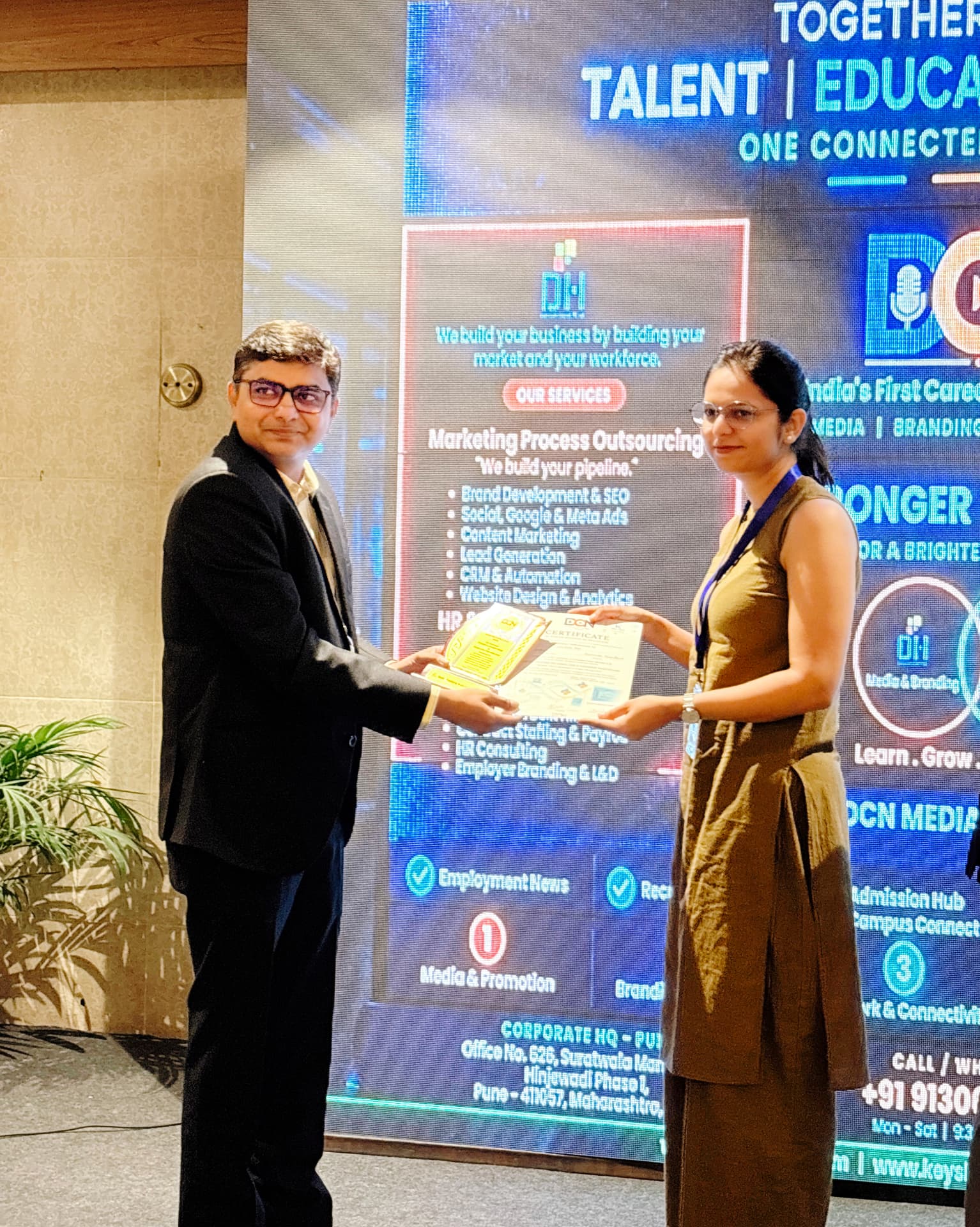 Delegate receiving a DCN memento and certificate on stage